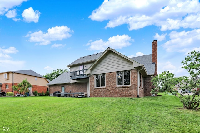 369 Rodeo Dr, Indianapolis, IN 46217 - back of house featuring brick siding, a chimney, a lawn, and a balcony