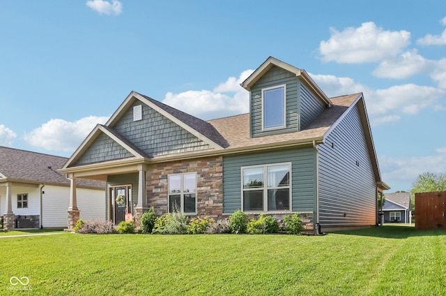 1209 E Wabash St, Frankfort, IN 46041 - craftsman-style home with a front yard, stone siding, and roof with shingles