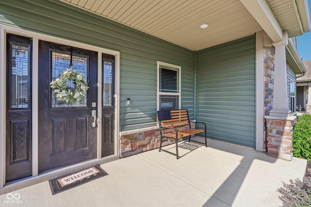 1209 E Wabash St, Frankfort, IN 46041 - doorway to property with covered porch and stone siding