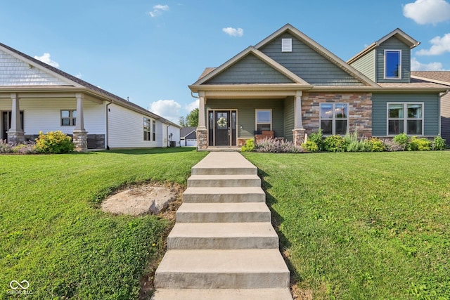 1209 E Wabash St, Frankfort, IN 46041 - craftsman-style house with a front yard, stone siding, and covered porch