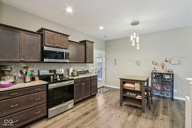 1209 E Wabash St, Frankfort, IN 46041 - kitchen featuring appliances with stainless steel finishes, dark brown cabinets, tasteful backsplash, light wood-type flooring, and recessed lighting