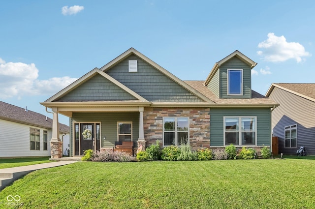 1209 E Wabash St, Frankfort, IN 46041 - back of property featuring covered porch, a lawn, stone siding, and a shingled roof