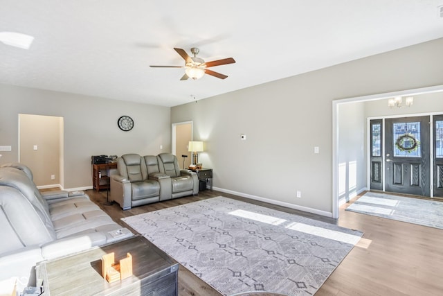 1209 E Wabash St, Frankfort, IN 46041 - living room featuring wood finished floors, a chandelier, and a ceiling fan