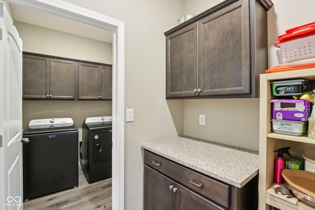 1209 E Wabash St, Frankfort, IN 46041 - washroom with washing machine and dryer, light wood finished floors, and cabinet space
