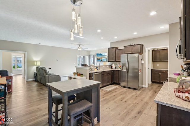 1209 E Wabash St, Frankfort, IN 46041 - kitchen with stainless steel appliances, dark brown cabinetry, healthy amount of natural light, light wood-style flooring, and recessed lighting