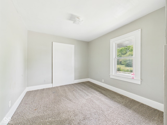 1201 Arrow Ave, Anderson, IN 46016 - spare room featuring carpet and baseboards