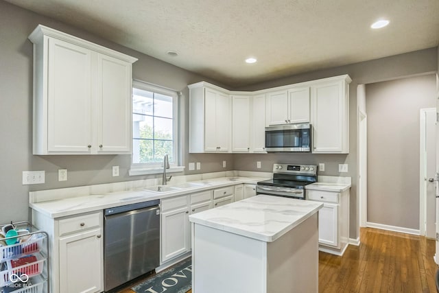 14156 Avalon E Dr, Fishers, IN 46037 - kitchen featuring stainless steel appliances, recessed lighting, white cabinets, dark wood-type flooring, and light stone counters