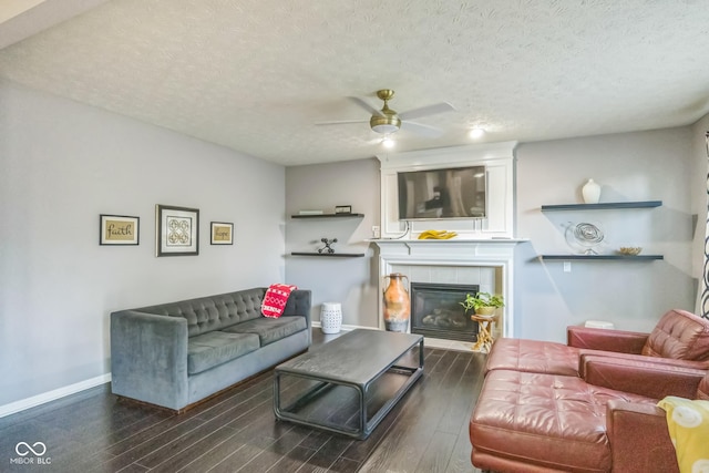 14156 Avalon E Dr, Fishers, IN 46037 - living area with ceiling fan, wood finished floors, a textured ceiling, and a tile fireplace