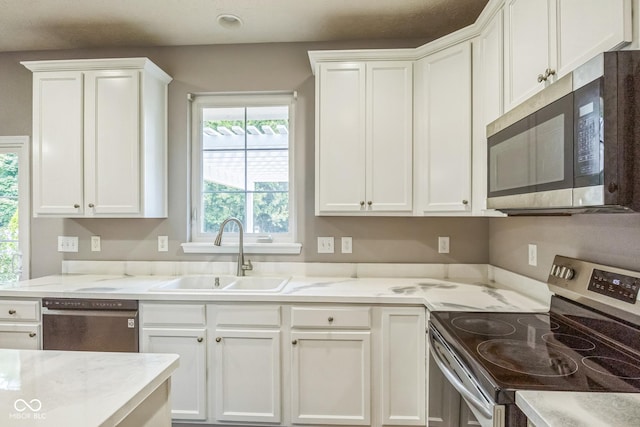 14156 Avalon E Dr, Fishers, IN 46037 - kitchen featuring stainless steel appliances, plenty of natural light, white cabinetry, and light stone countertops