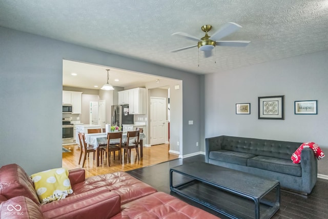 14156 Avalon E Dr, Fishers, IN 46037 - living area with ceiling fan, light wood finished floors, recessed lighting, and a textured ceiling
