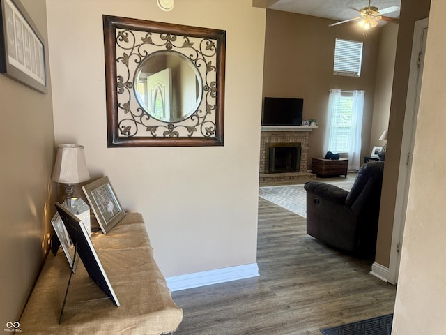 4065 W New Castle Rd, Frankfort, IN 46041 - living area featuring wood finished floors, a ceiling fan, and a brick fireplace