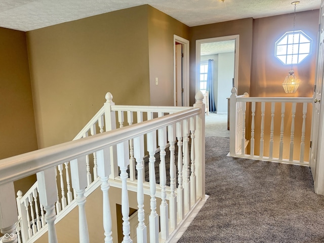 4065 W New Castle Rd, Frankfort, IN 46041 - hallway with an upstairs landing, carpet floors, and a textured ceiling