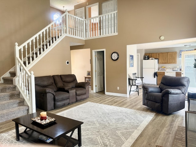 4065 W New Castle Rd, Frankfort, IN 46041 - living room with a towering ceiling, light wood-style flooring, and stairway
