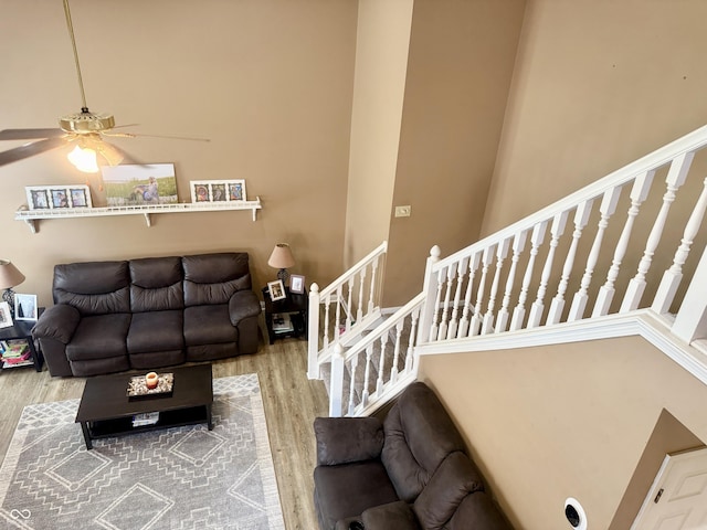 4065 W New Castle Rd, Frankfort, IN 46041 - living room with wood finished floors, stairs, ceiling fan, and a high ceiling