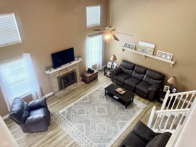 4065 W New Castle Rd, Frankfort, IN 46041 - living area with a high ceiling, wood finished floors, a ceiling fan, plenty of natural light, and a fireplace
