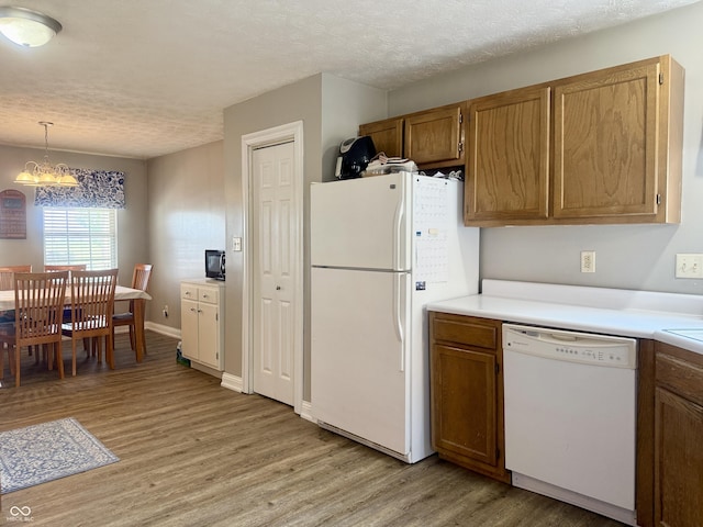 4065 W New Castle Rd, Frankfort, IN 46041 - kitchen featuring white appliances, light wood finished floors, a chandelier, light countertops, and a textured ceiling