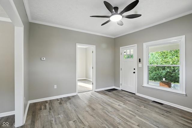 1430 W 14th St, Anderson, IN 46016 - foyer with a ceiling fan, wood finished floors, and crown molding