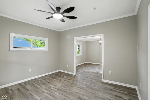 1430 W 14th St, Anderson, IN 46016 - unfurnished room with healthy amount of natural light, wood finished floors, ornamental molding, and a ceiling fan