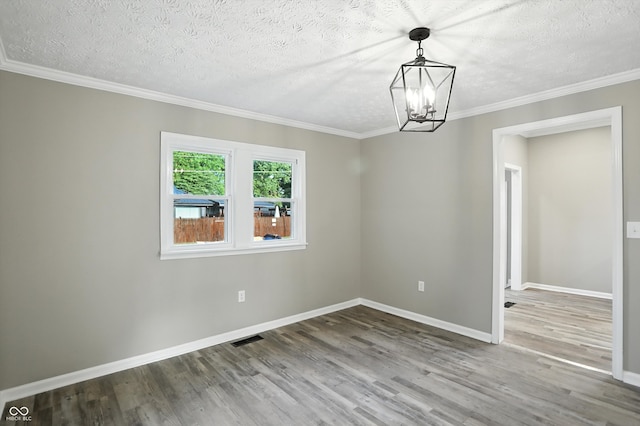 1430 W 14th St, Anderson, IN 46016 - unfurnished room with wood finished floors, a chandelier, a textured ceiling, and crown molding