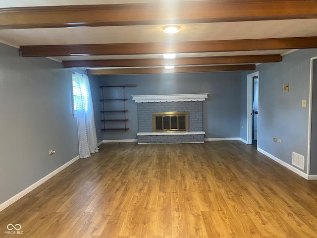 8008 Cherington Dr, Indianapolis, IN 46227 - unfurnished living room featuring beamed ceiling, a fireplace, and wood finished floors