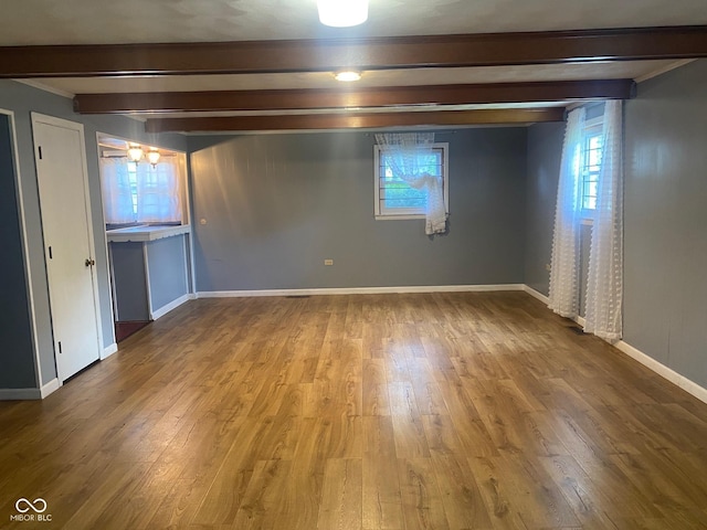 8008 Cherington Dr, Indianapolis, IN 46227 - empty room with beam ceiling and wood finished floors