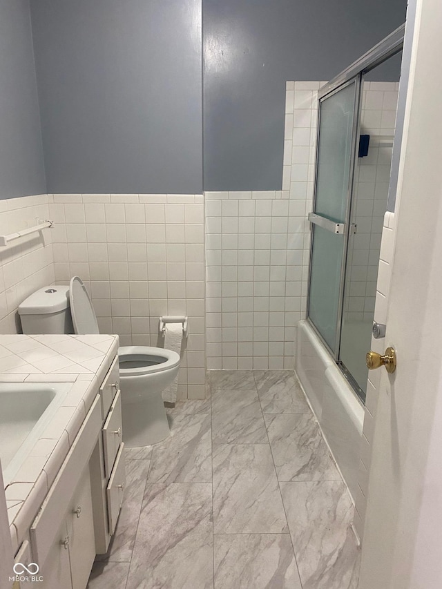 8008 Cherington Dr, Indianapolis, IN 46227 - full bath with tile walls, marble finish flooring, vanity, and shower / bath combination with glass door