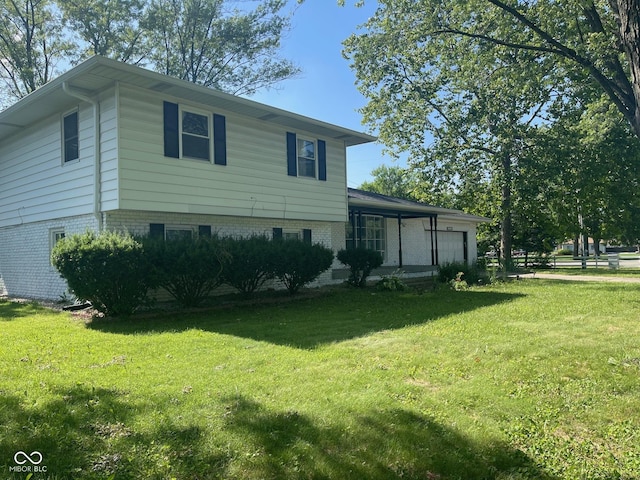 8008 Cherington Dr, Indianapolis, IN 46227 - view of front of property with a garage, a front yard, and brick siding