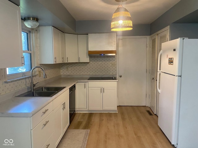8008 Cherington Dr, Indianapolis, IN 46227 - kitchen featuring black appliances, light wood-type flooring, white cabinetry, and backsplash