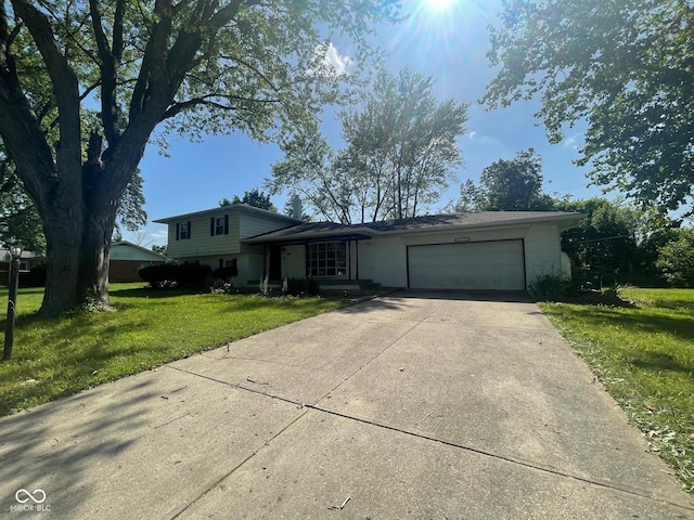 8008 Cherington Dr, Indianapolis, IN 46227 - split level home featuring a garage, a front lawn, concrete driveway, and brick siding