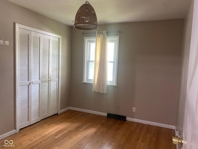 8008 Cherington Dr, Indianapolis, IN 46227 - unfurnished bedroom featuring light wood-type flooring and a closet