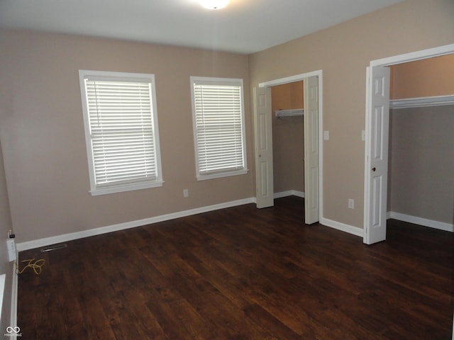 2502 N Harding St, Indianapolis, IN 46208 - unfurnished bedroom with dark wood-type flooring and multiple windows