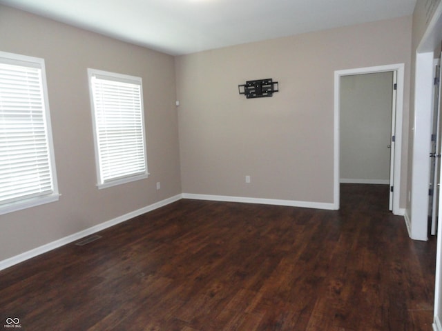 2502 N Harding St, Indianapolis, IN 46208 - spare room featuring dark wood-style flooring and baseboards