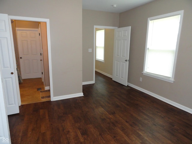2502 N Harding St, Indianapolis, IN 46208 - unfurnished bedroom featuring dark wood finished floors and baseboards
