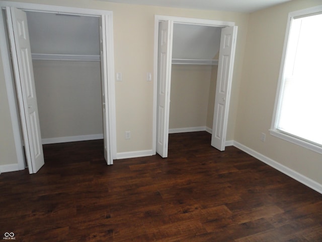 2502 N Harding St, Indianapolis, IN 46208 - unfurnished bedroom with multiple closets and dark wood finished floors