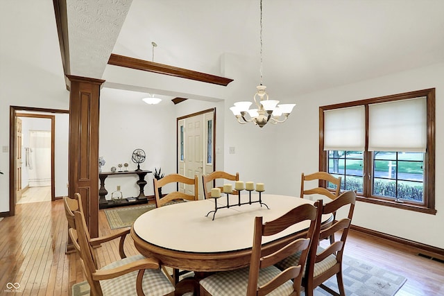 1456 Bent Tree Pl, Greenwood, IN 46143 - dining room featuring light wood-style floors, decorative columns, a chandelier, and lofted ceiling