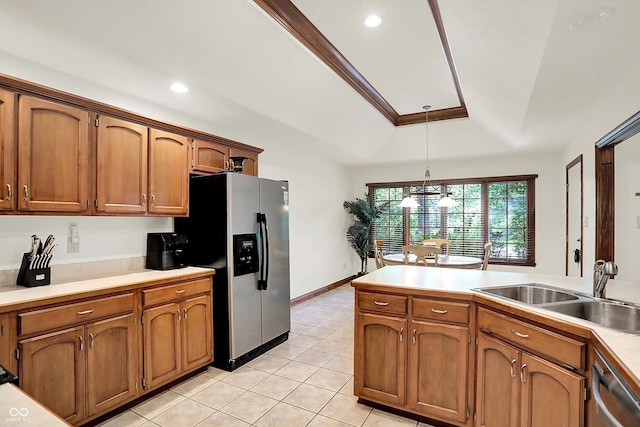 1456 Bent Tree Pl, Greenwood, IN 46143 - kitchen featuring stainless steel appliances, brown cabinetry, light countertops, decorative light fixtures, and light tile patterned floors