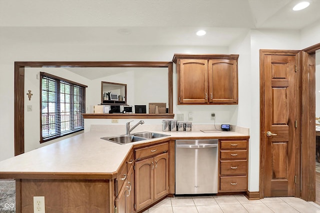 1456 Bent Tree Pl, Greenwood, IN 46143 - kitchen featuring stainless steel dishwasher, a peninsula, light countertops, light tile patterned flooring, and brown cabinets