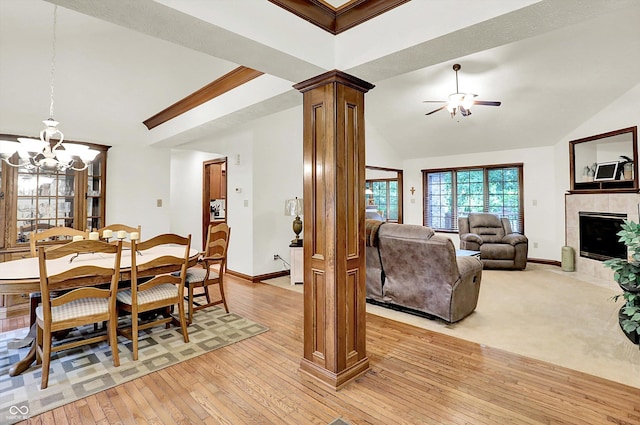 1456 Bent Tree Pl, Greenwood, IN 46143 - dining room featuring decorative columns, light wood finished floors, a chandelier, ceiling fan, and a tile fireplace