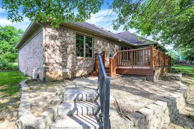 1456 Bent Tree Pl, Greenwood, IN 46143 - back of house with a wooden deck, brick siding, roof with shingles, and a patio