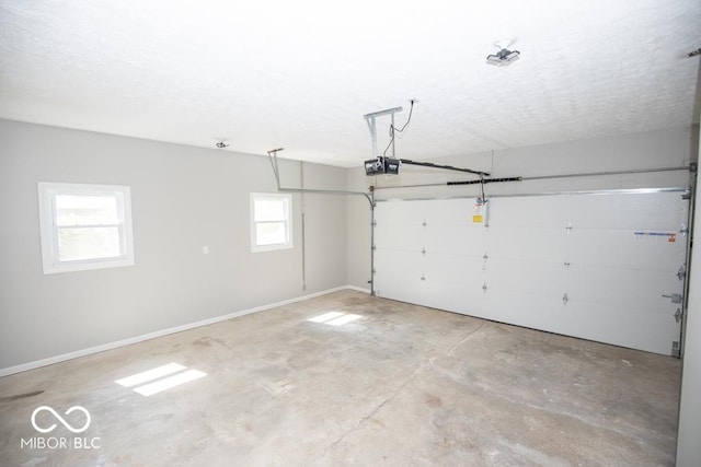 1855 E Deb Dr, North Vernon, IN 47265 - garage featuring a garage door opener and baseboards