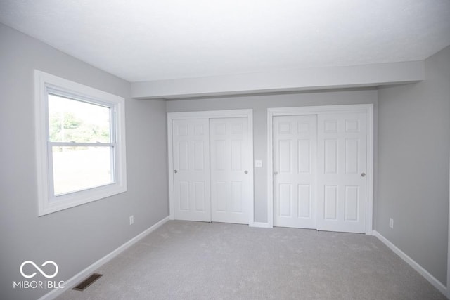 1855 E Deb Dr, North Vernon, IN 47265 - unfurnished bedroom featuring two closets and carpet