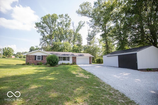 1855 E Deb Dr, North Vernon, IN 47265 - ranch-style home with a front yard, a garage, asphalt driveway, and an outbuilding
