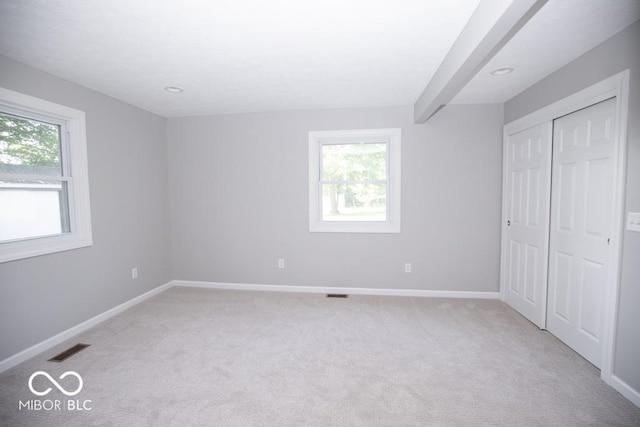1855 E Deb Dr, North Vernon, IN 47265 - unfurnished bedroom with multiple windows, light colored carpet, a closet, and recessed lighting