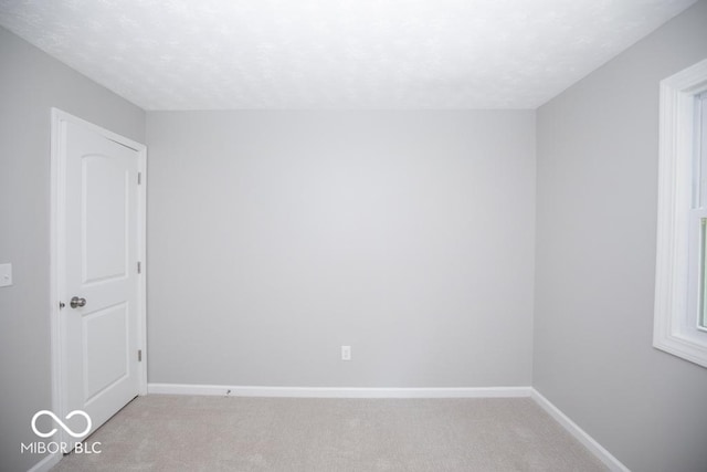 1855 E Deb Dr, North Vernon, IN 47265 - empty room featuring light carpet and a textured ceiling