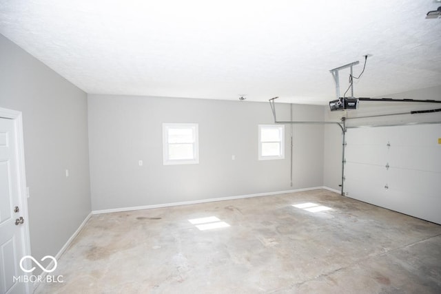 1855 E Deb Dr, North Vernon, IN 47265 - garage with a garage door opener and baseboards