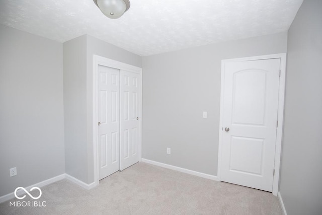 1855 E Deb Dr, North Vernon, IN 47265 - unfurnished bedroom with a closet, carpet floors, and a textured ceiling