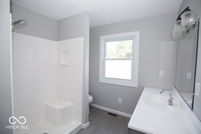 1855 E Deb Dr, North Vernon, IN 47265 - bathroom with wood finished floors, vanity, and a shower