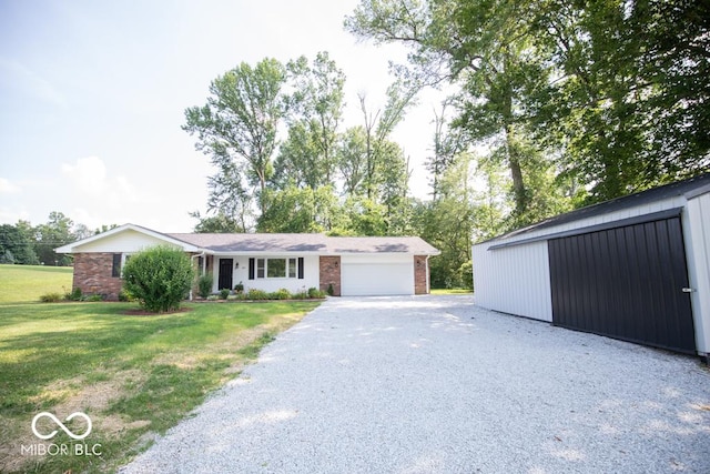 1855 E Deb Dr, North Vernon, IN 47265 - view of front of house with brick siding, gravel driveway, a front yard, and a garage