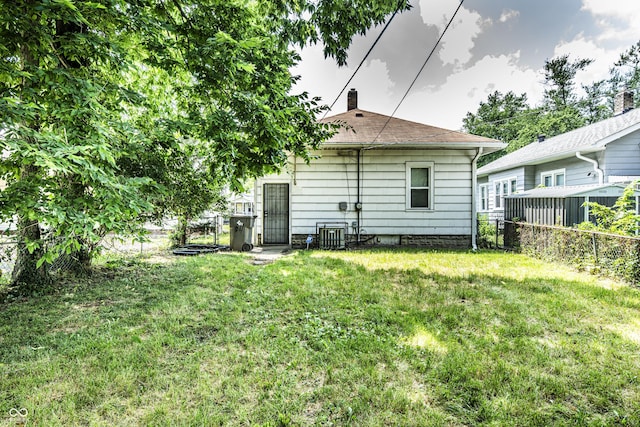 611 N Bradley Ave, Indianapolis, IN 46201 - rear view of property featuring a fenced backyard and a chimney
