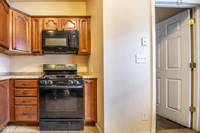 611 N Bradley Ave, Indianapolis, IN 46201 - kitchen with black appliances, brown cabinets, and light countertops